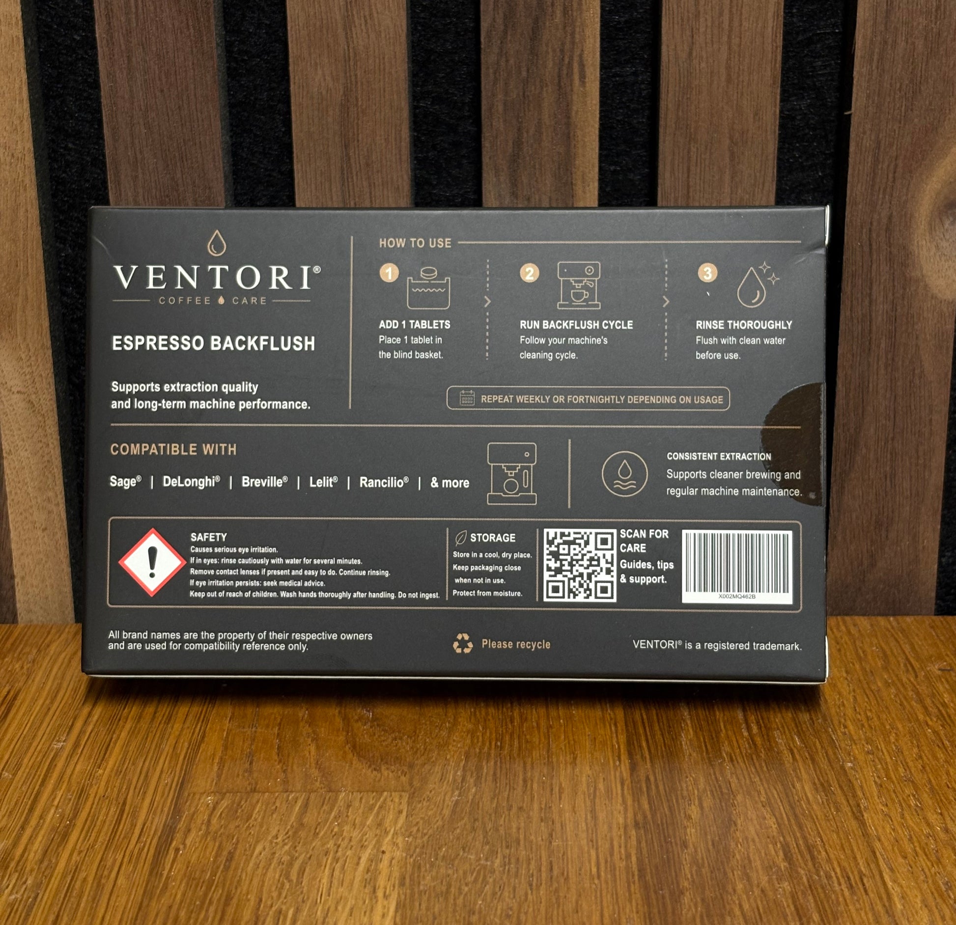 The back of a Ventori Coffee Dose box for Espresso Backflush tablets, displayed on a wooden surface. The box is dark gray with white text and icons detailing usage, compatibility with Sage, De'Longhi, Breville, Latte, and Rancilio machines, and features a QR code.