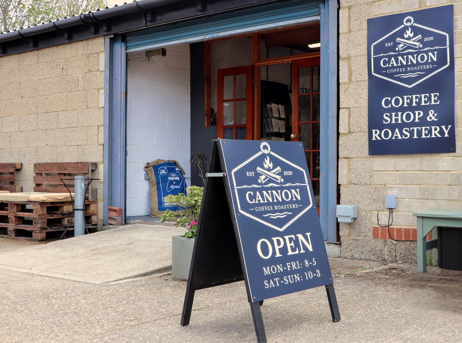 Cannon Coffee Roasters coffee shop and roastery with an open sign outside.